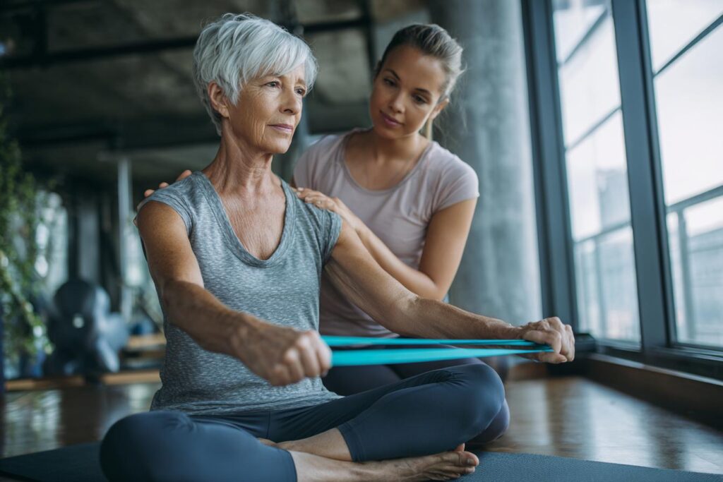 older woman pilates wtih instructor